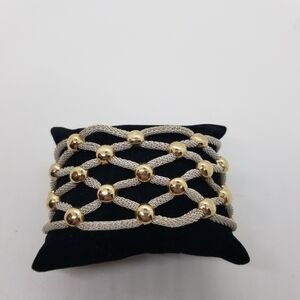 silver tone mesh tube woven bracelet with gold tone accents